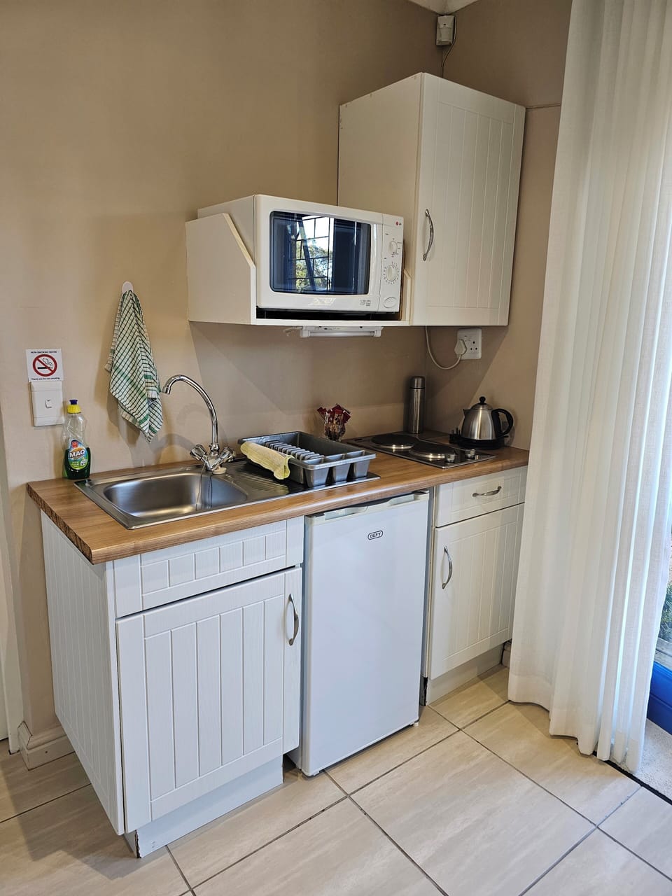 Fridge, microwave, electric kettle, cookware/dishes/utensils