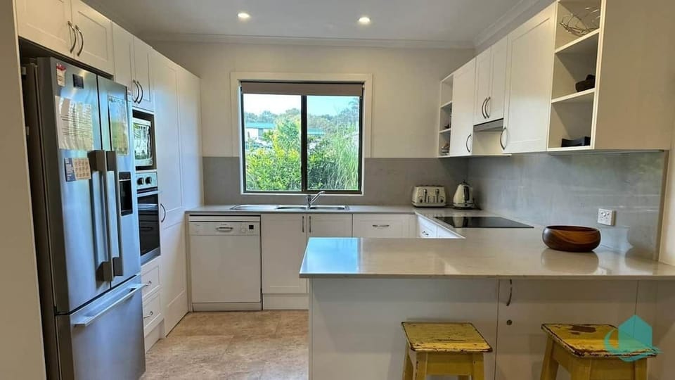 Modernised kitchen with full sized fridge and dishwasher