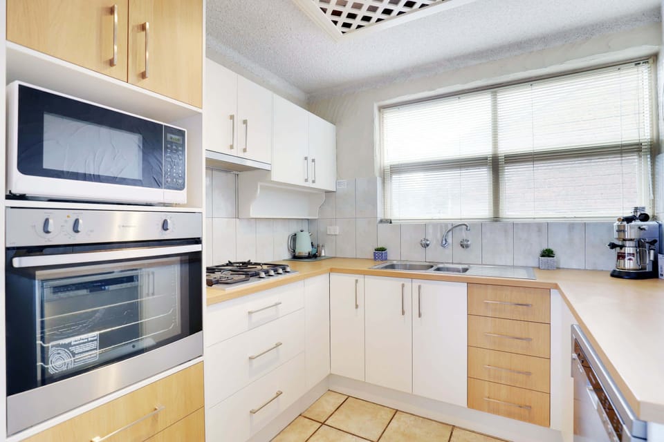 kitchen feature gas stove, oven, microwave, kettle, toaster & dishwasher.
