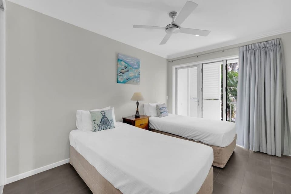 The third bedroom comes with two single beds and access to the balcony. 