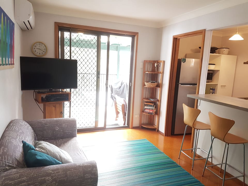 Breakfast Bar to kitchen and access to outside dining area and BBQ,