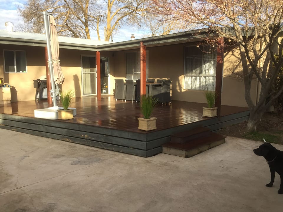Balcony/patio at rear with weber q and 8 seater setting.