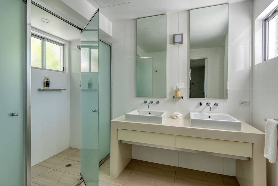 A second bathroom caters to groups, with dual vanities and a walk-in shower.