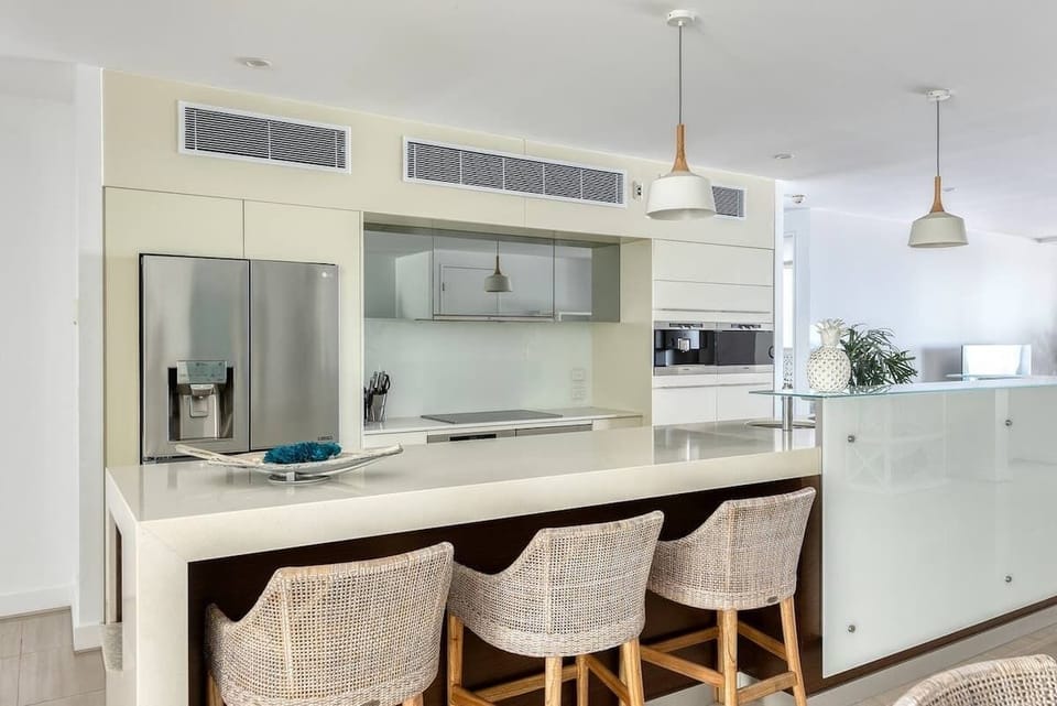 The kitchen centres around a central island, where you can enjoy conversations with the cook while entertaining.