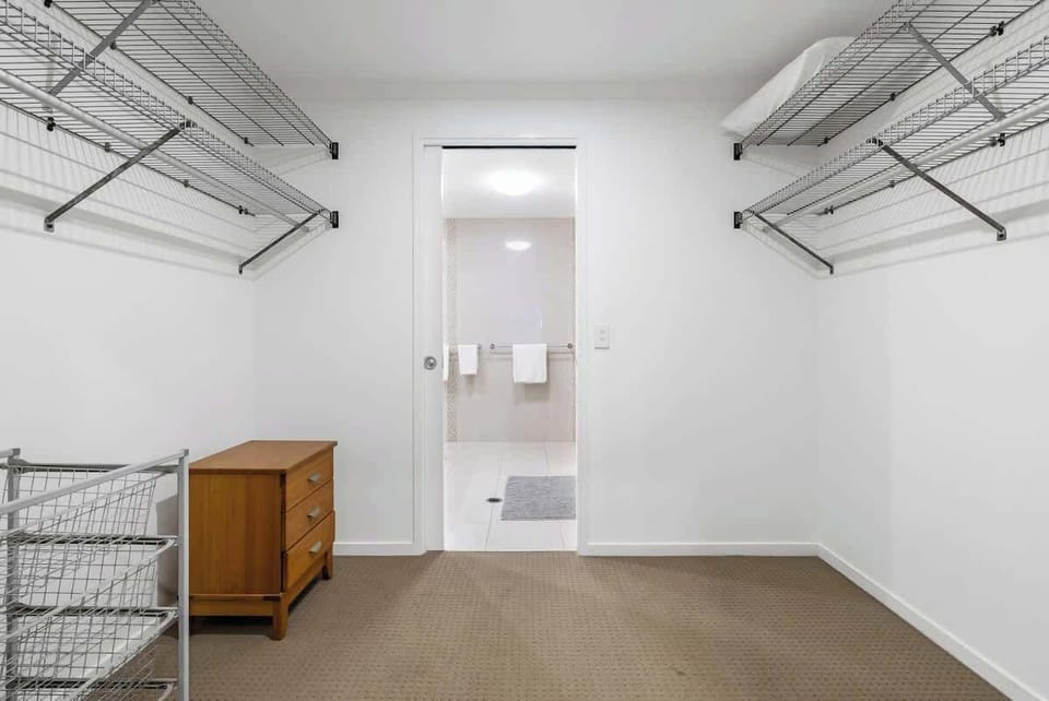 The primary bedroom opens up to a spacious walk-in robe and attached ensuite bathroom.