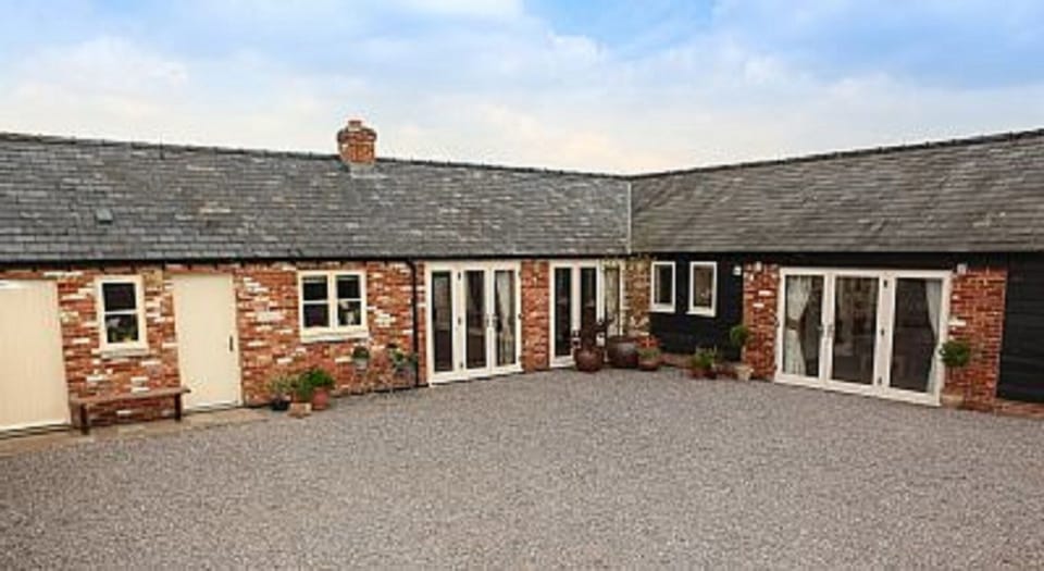 Courtyard showing Txoko Cottage (left) and Little Owls Cottage (right)