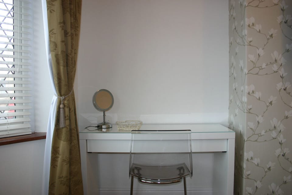 Bathroom with bath and thermo shower fed from combi boiler