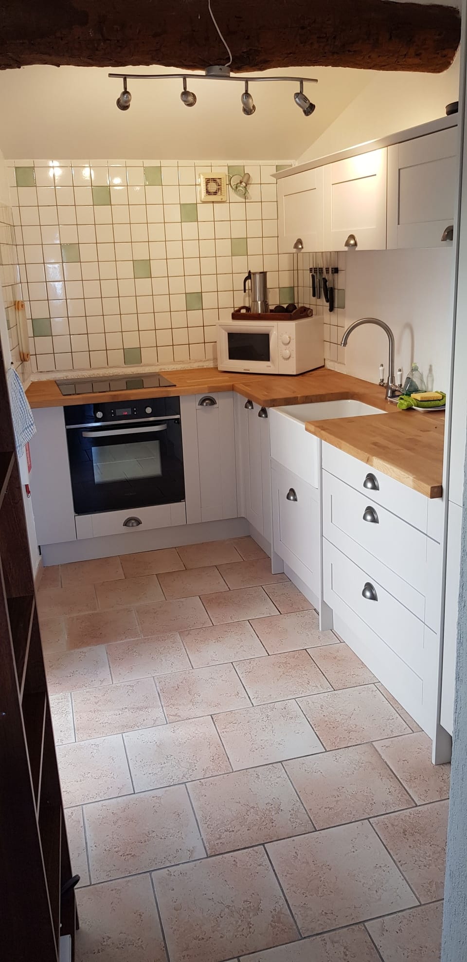 A fully equiped kitchen with fridge/freezer and doors onto a small balcony. 