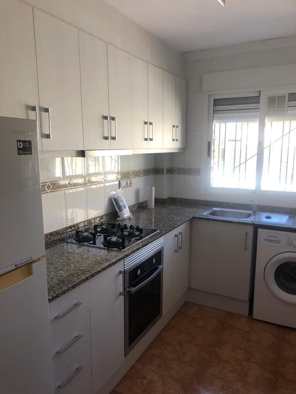 Kitchen with all necessary utensils and a washing machine