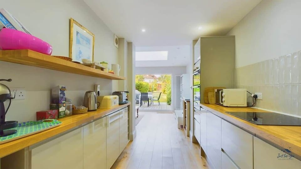 Kitchen/Dining area overlooking the garden, creating a bright and sociable space for shared meals.
