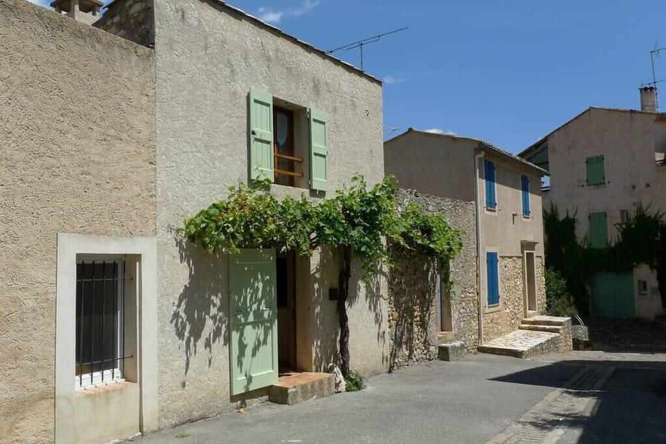 The front door is framed by an ancient vine