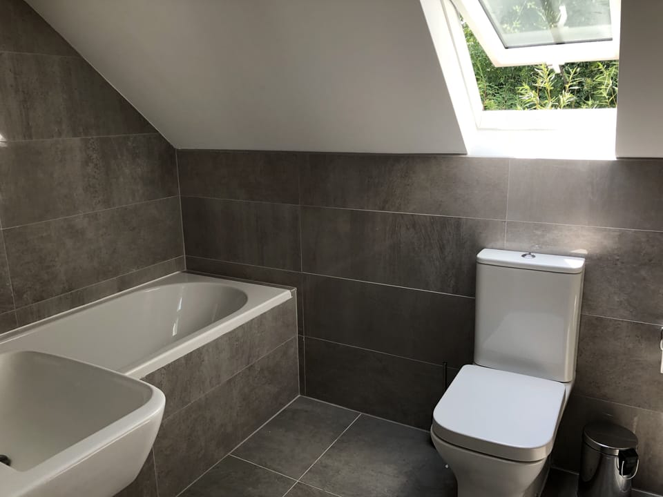 Main bathroom with bath, separate shower, sink and toilet and underfloor heating
