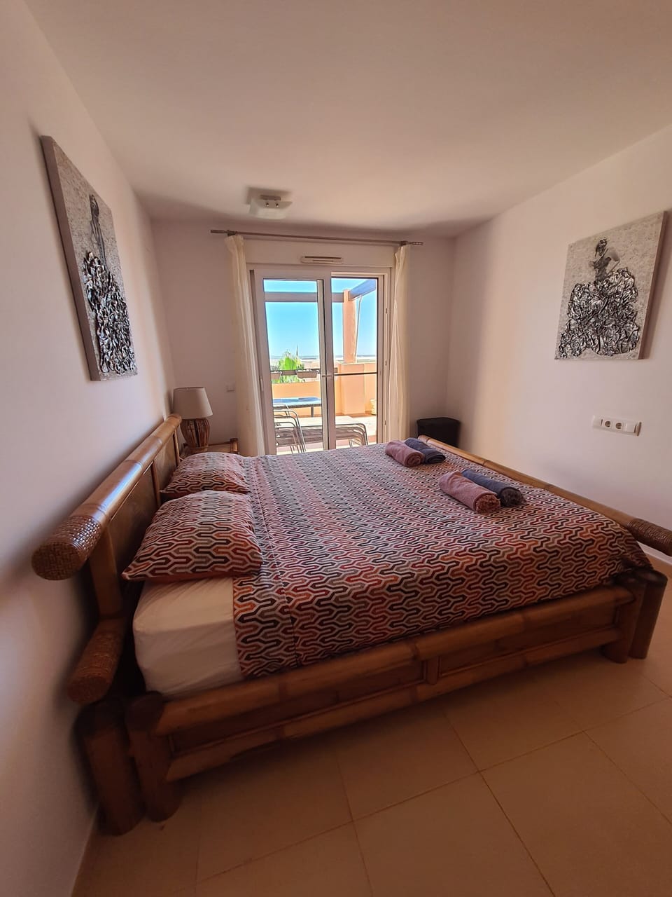 Main bedroom with super-king sized bed and patio door to terrace.