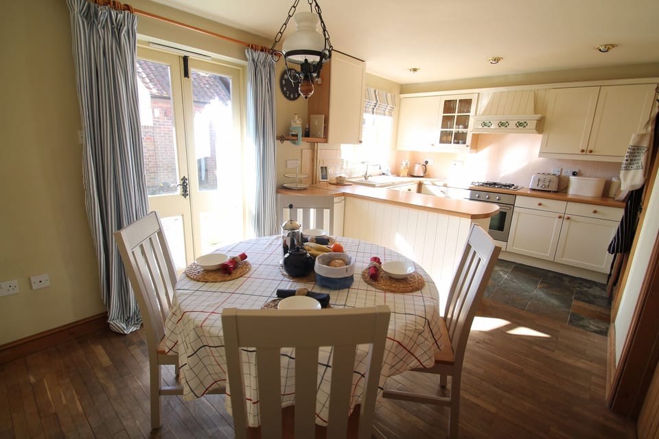 Light and sunny dining area with seating for 5 plus high chair if required.