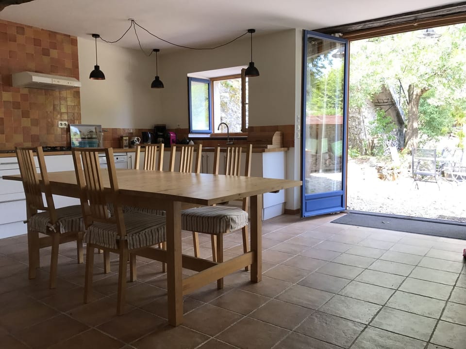 Downstairs open plan kitchen and dining area with doors to the courtyard.