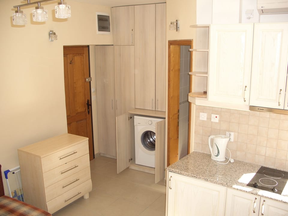 Looking from windows to kitchenette, wardrobe & front door- bathroom door centre