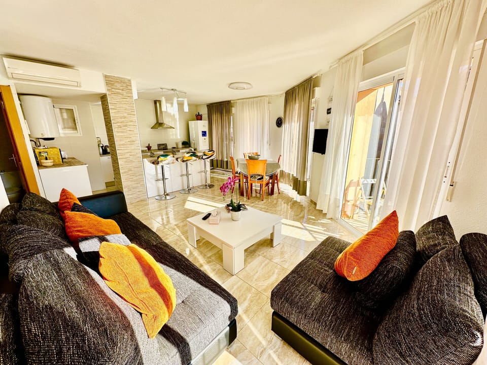 a big living room with kitchen and dining table that can open and be 180cm 