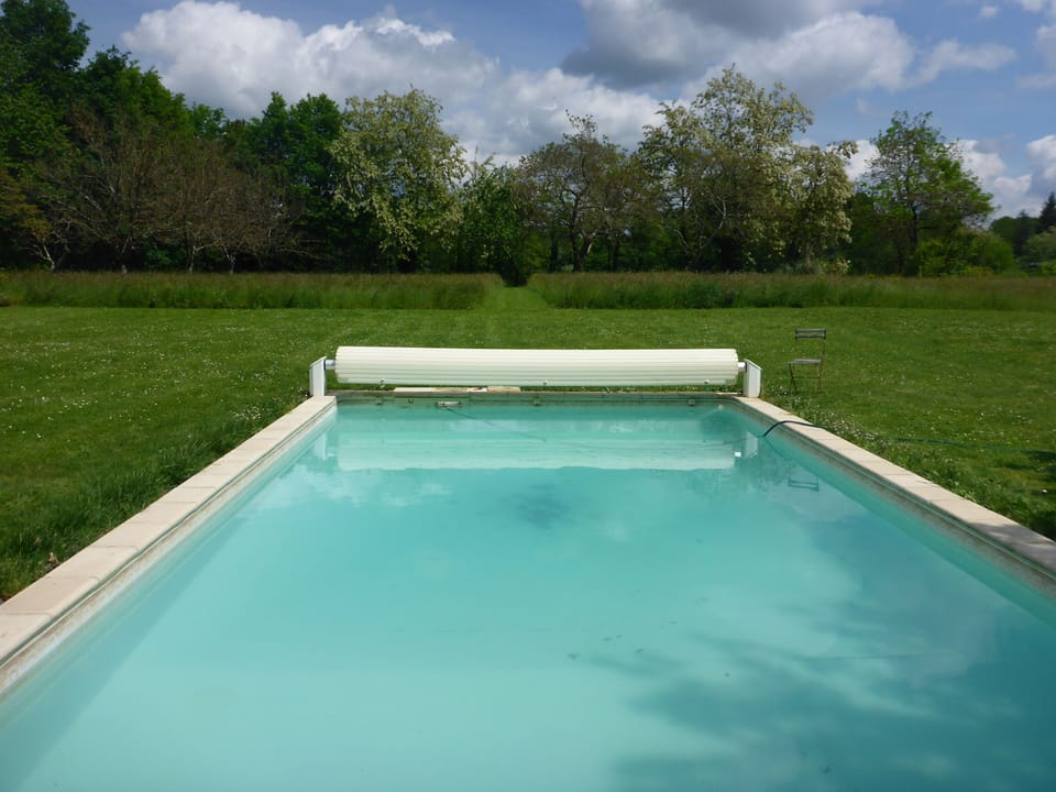 From the pool, through the flowers to the river and riverside picnic table