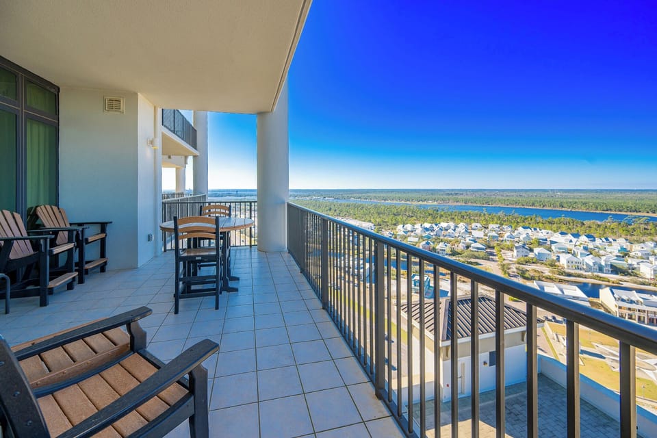 This balcony features comfortable seating and a table, offering a view of the surrounding area from the twentieth floor