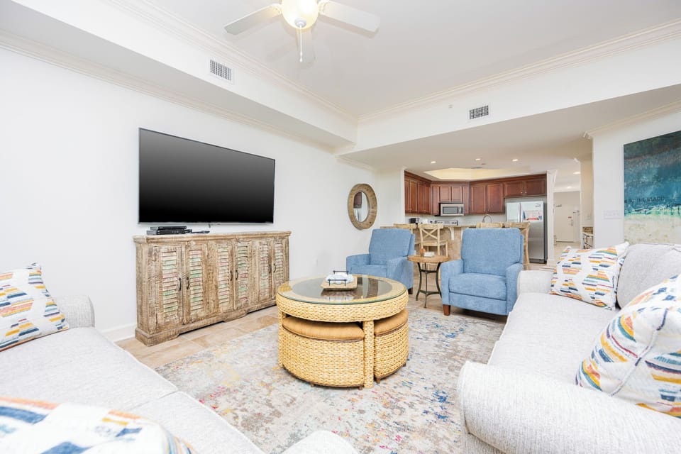 This living area features a large TV, cozy seating, and a stylish coffee table, creating a perfect spot for relaxation