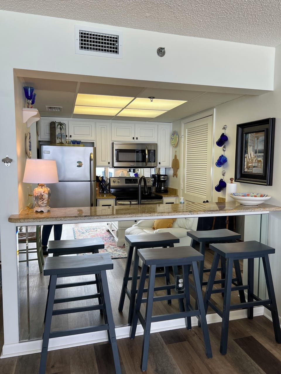 Breakfast Bar with Mirrors and Granite Countertops
