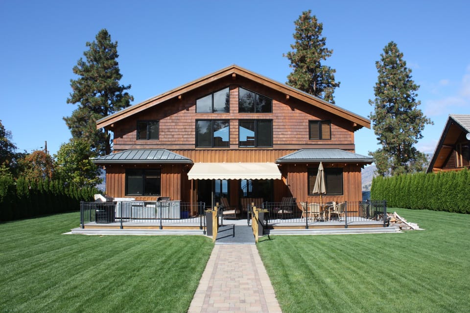 Back of house with outdoor kitchen and retractable canopy for hot days