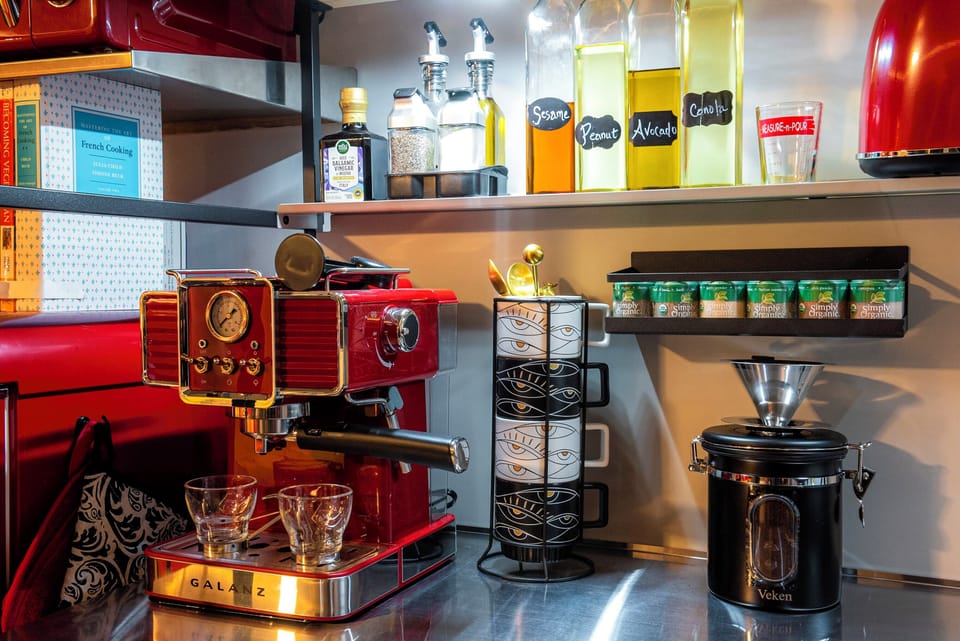 The petite yet complete kitchen is a gourmand's dream with an espresso maker, an induction cooktop