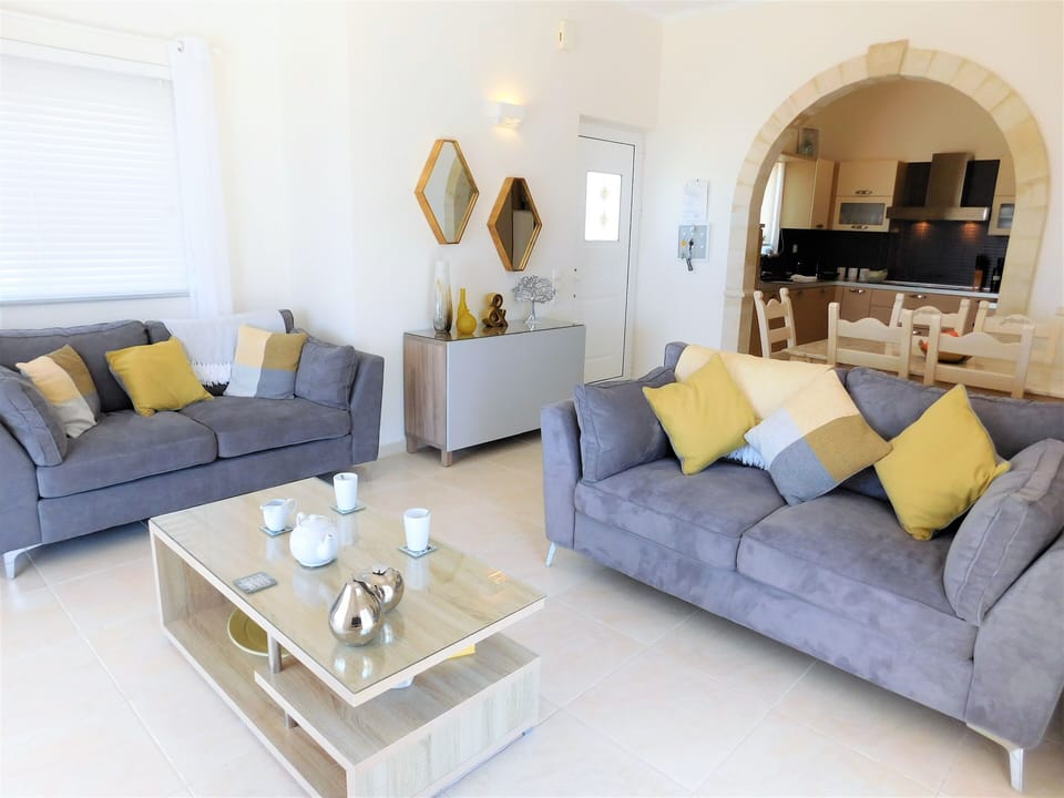 Villa Eleni open plan living and dining room with archway to kitchen.