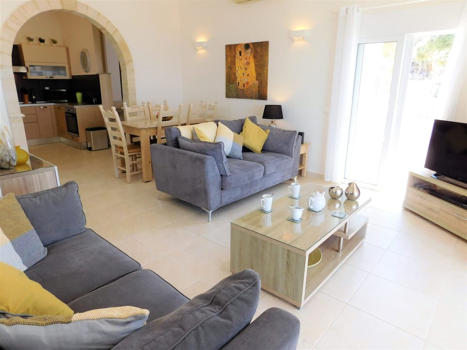 Villa Eleni living room with doors to pool terrace.