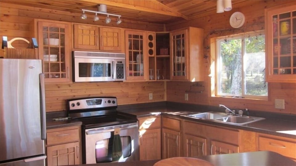 Full kitchen with all maple cabinets and stainless steel appliances.