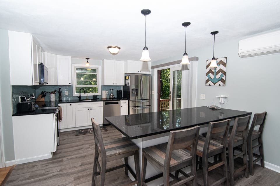 New Modern kitchen, with bar seating, slider to deck