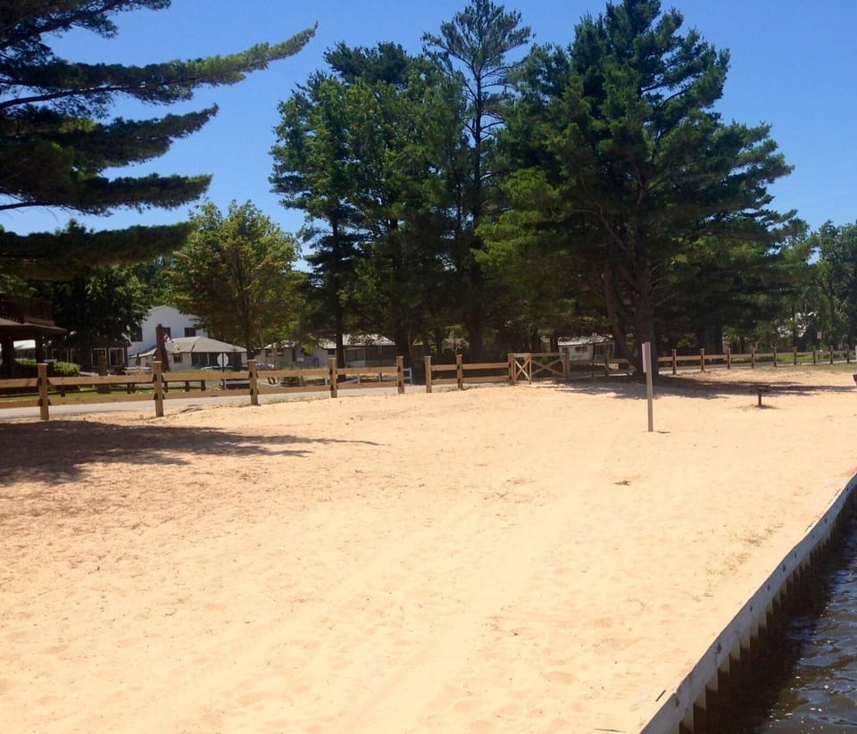 Nice sandy beach, swimming dock with steps into lake available just to the left