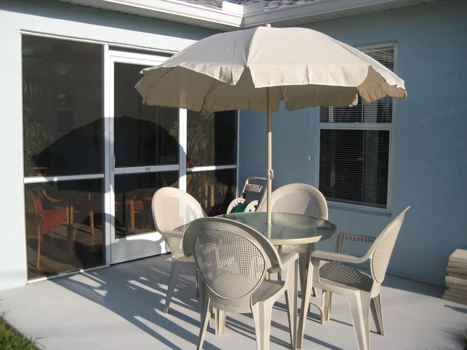 10 by 10 patio with new gas grill, and patio set with umbrella.