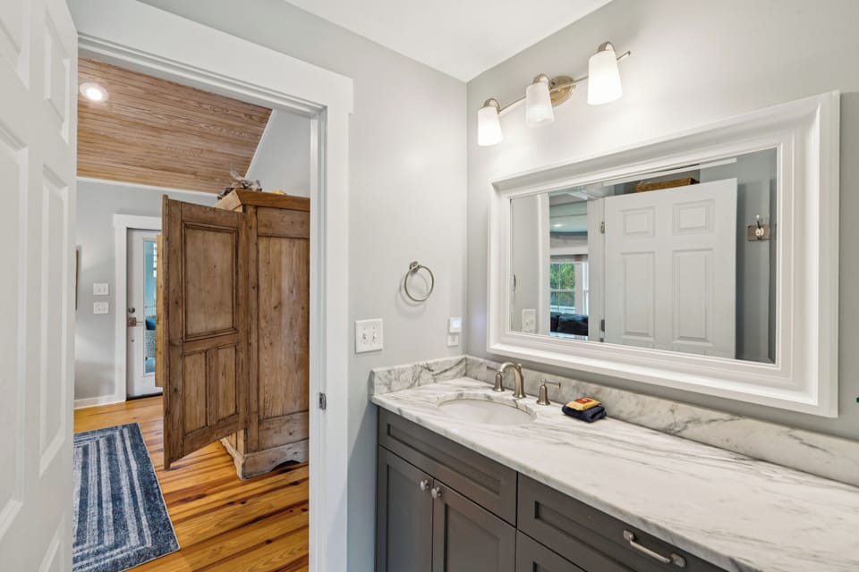 There is one shared bathroom that features a standing shower.