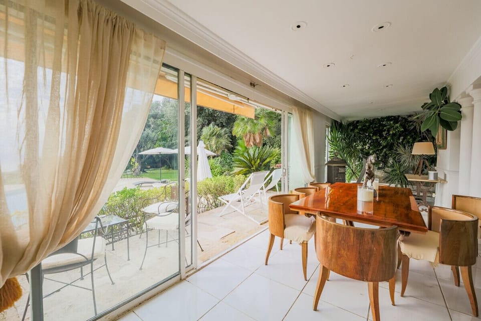 Another view of the dining area with a view of the swimming pool