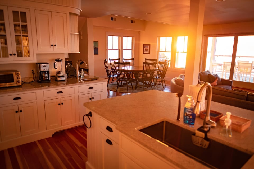 kitchen with view toward dining room table during sunrise