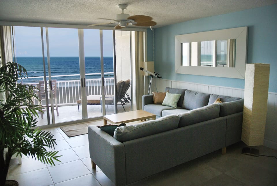 Open concept living room with beach and ocean view.