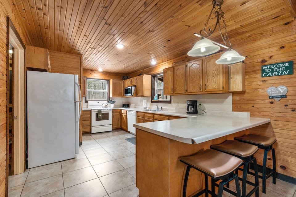 Large stocked kitchen with full size fridge, dishwasher and electric range