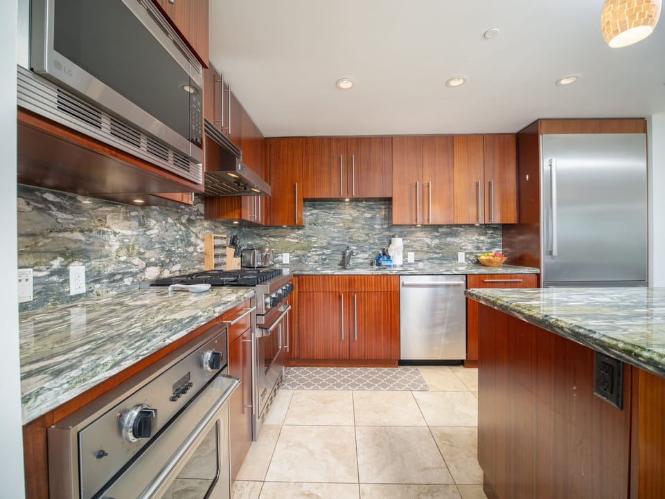 Fully equipped gourmet kitchen with premium stainless steel appliances and spacious counters, perfect for cooking enthusiasts and family gatherings.