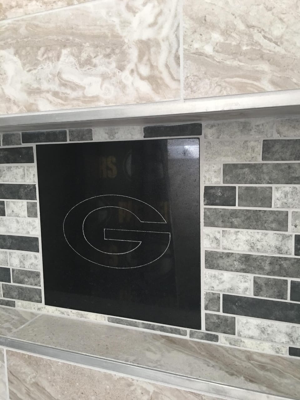 Shower room has custom etched Packers "G" . How cool is that?