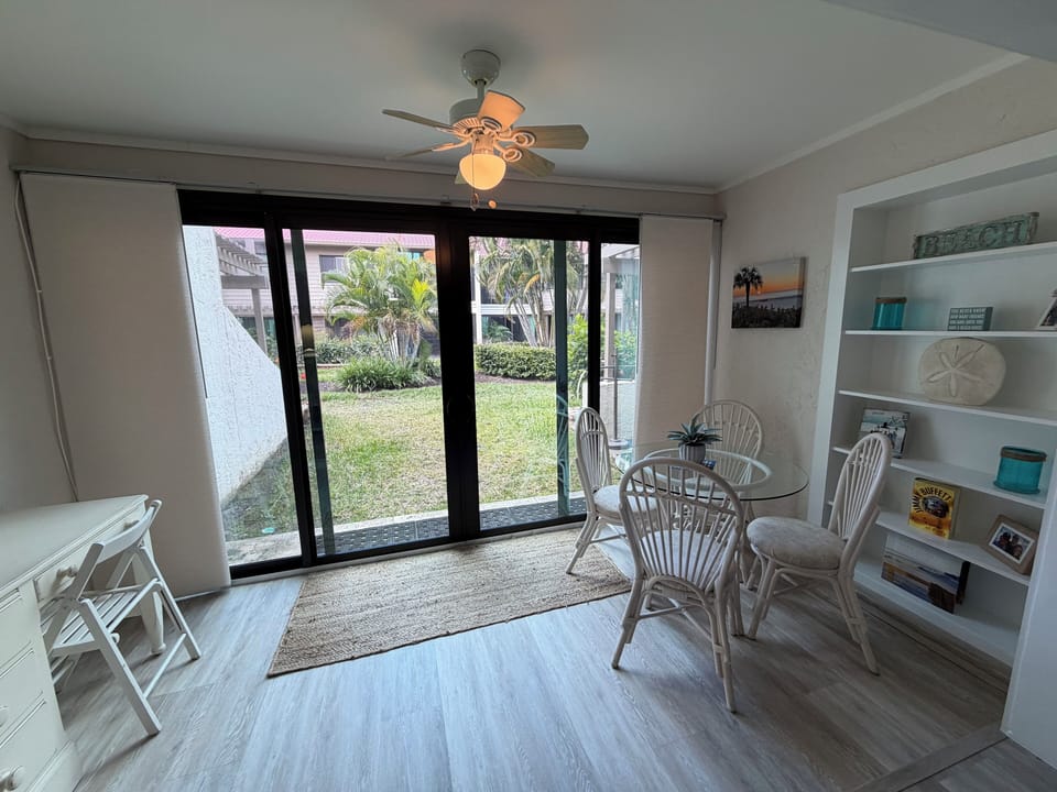 Your bright dining space opens to peaceful garden views, where coastal breezes flow through sliding doors.