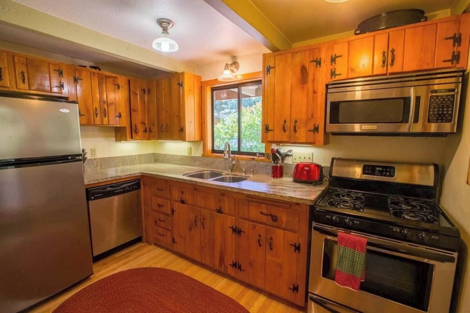 Full kitchen with range/stove, microwave, dishwasher, pots, pans, coffee machine, and coffee grinder. We provide basic spices, oils, and coffee beans.