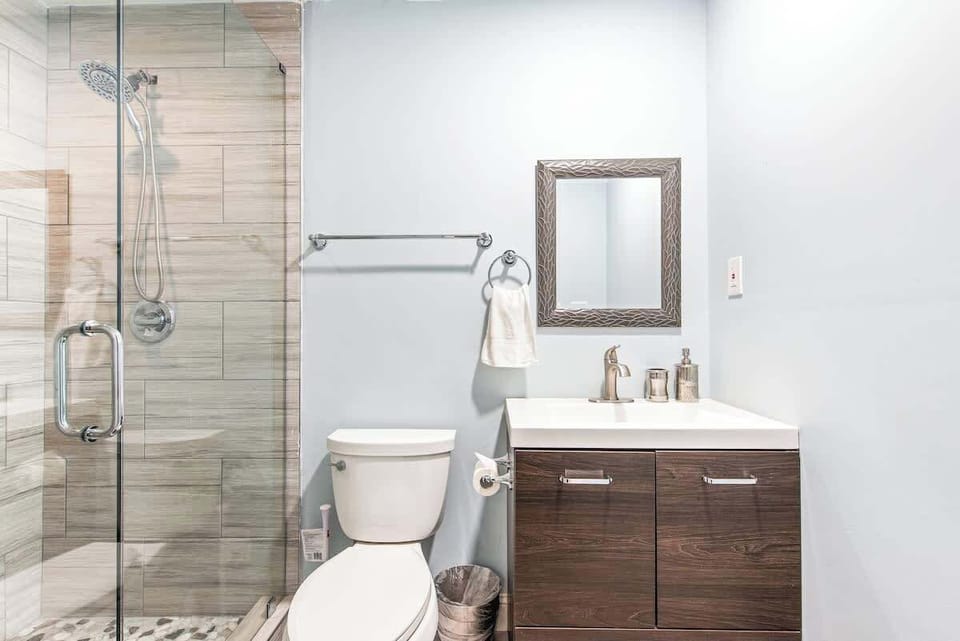 One of three full bathrooms on main floor, connected to guest bedroom