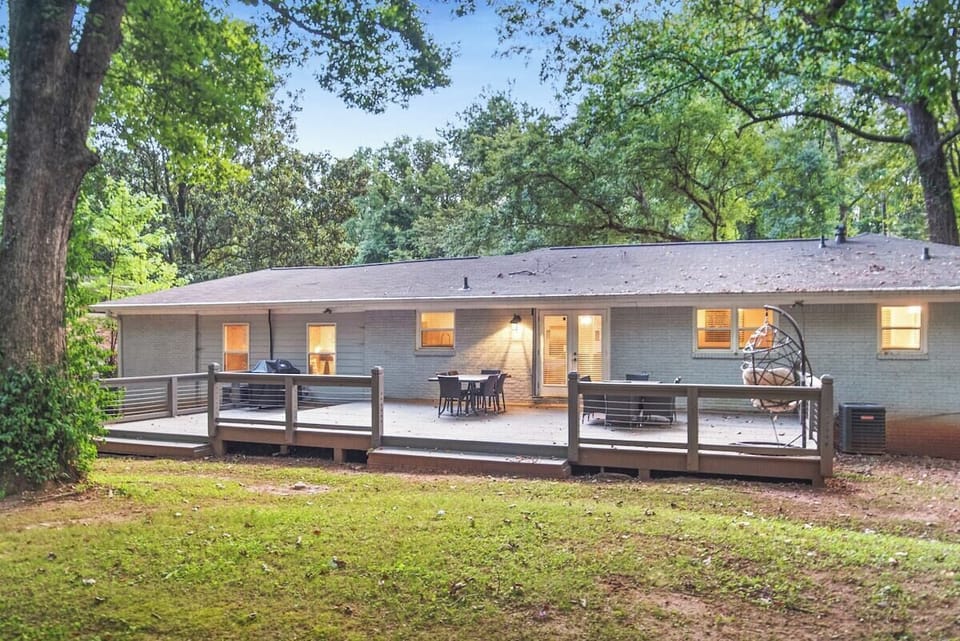 Spacious deck in the backyard with propane grill, outdoor dining area and lounge space