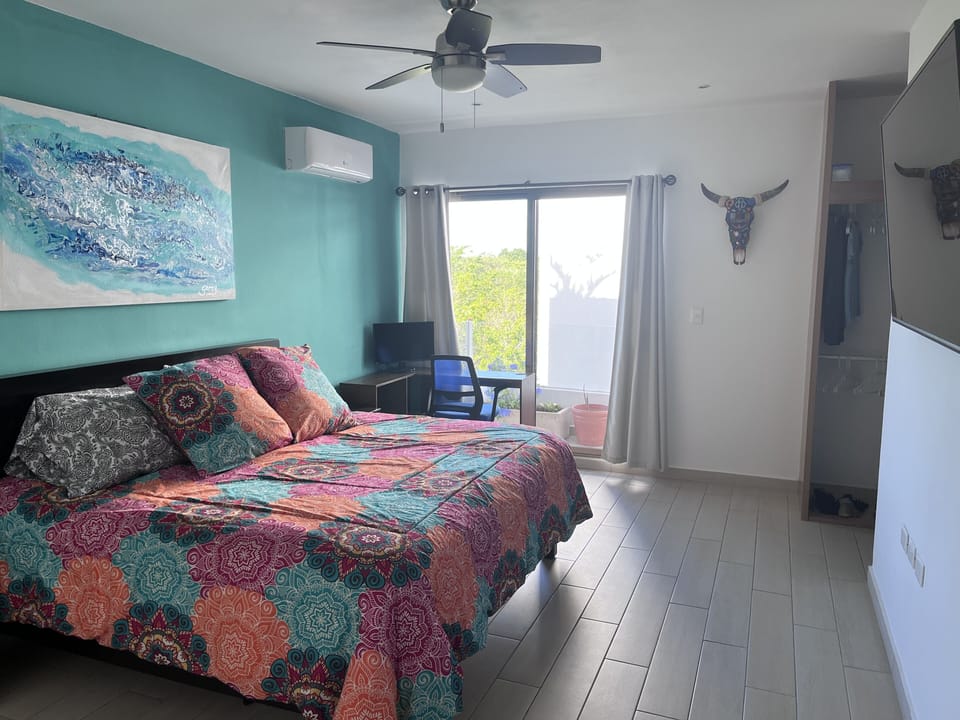 Very room master bedroom with 65" TV, A/C and ceiling fan.  