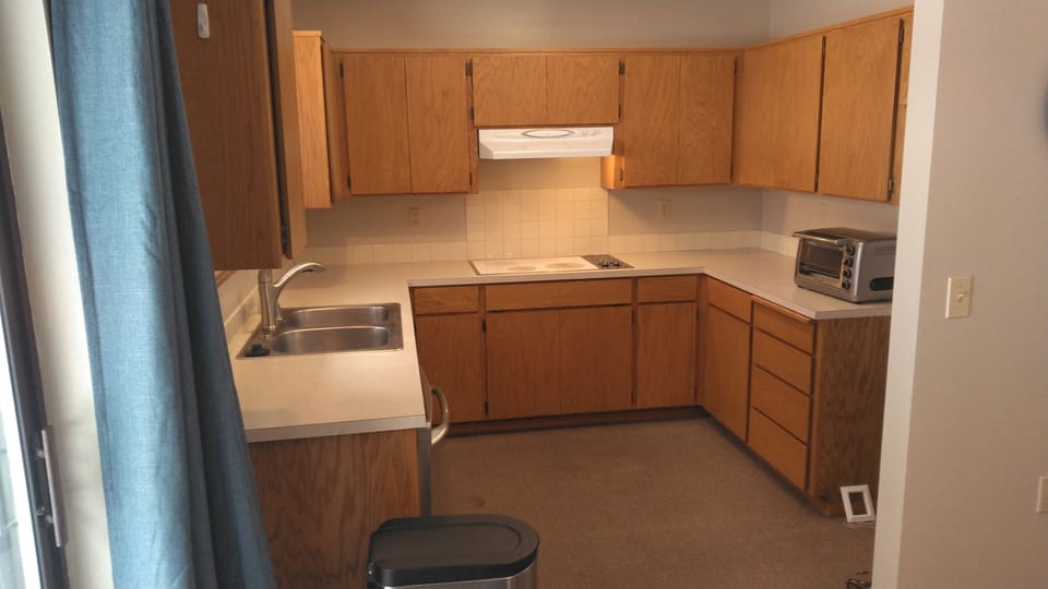 Kitchen with toaster oven, ceramic stove top, dishwasher