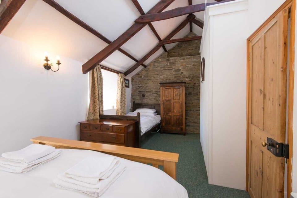 Bedroom 1 sleeps 3 in king-size and single beds, there is space for a cot also