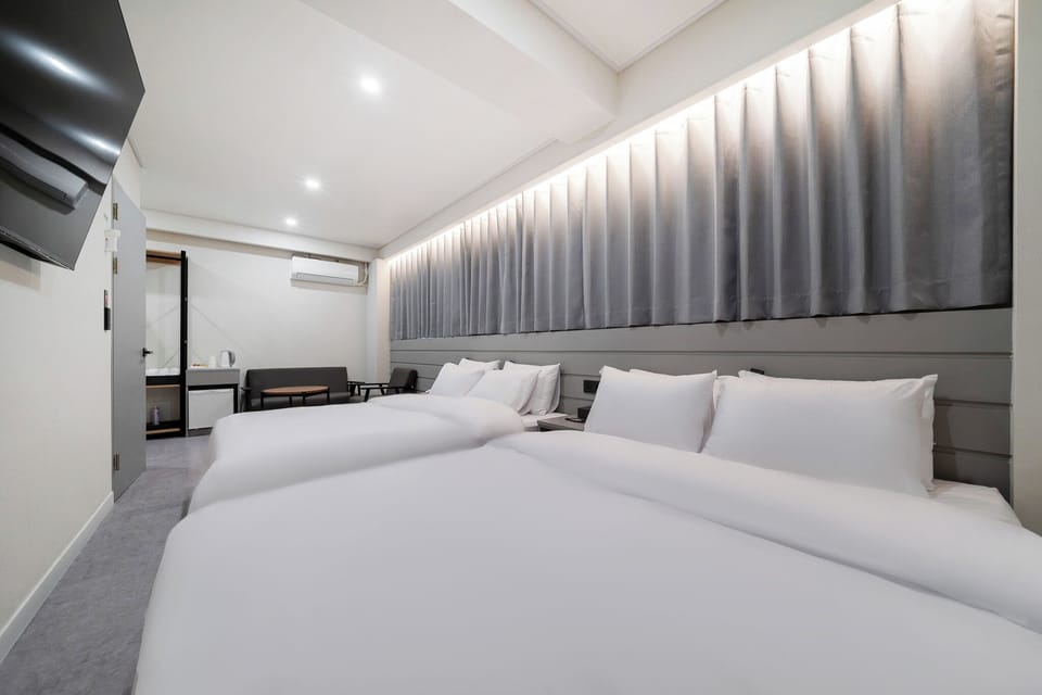 Family Room, 2 Queen Beds, Non-Smoking, City View, No Parking, Check-in after 6 PM | Down comforters, memory foam beds, desk, laptop workspace