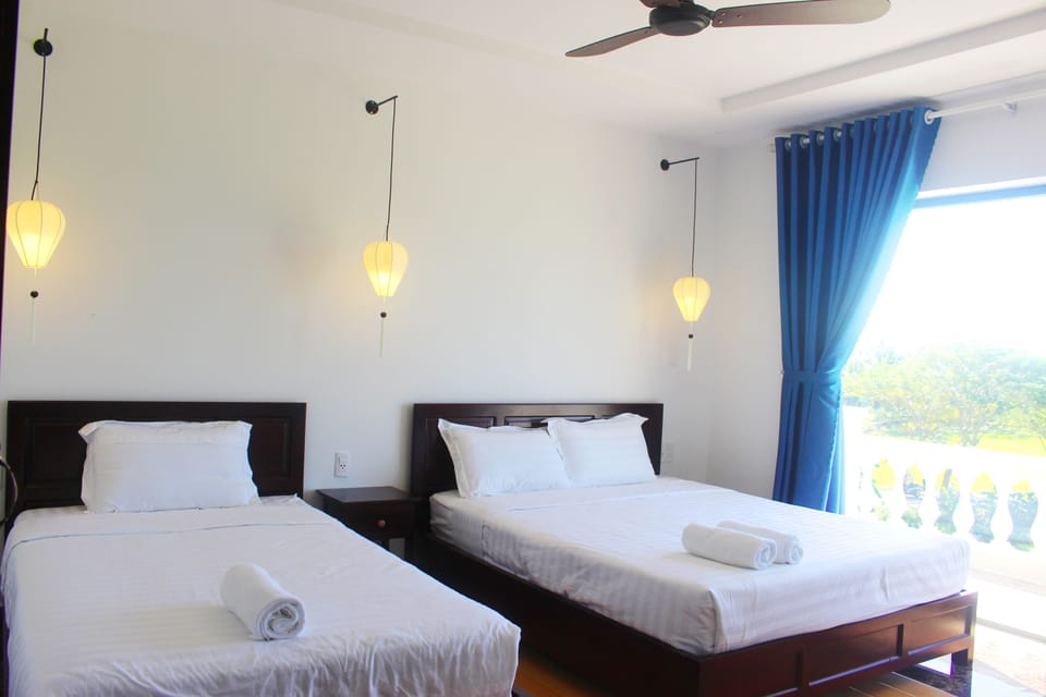 Deluxe Triple Room, Garden View | Minibar, desk, soundproofing, iron/ironing board