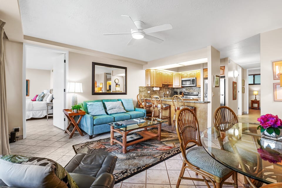 A bright and airy living space featuring cozy seating, island-inspired décor, and easy access to the balcony—perfect for a relaxing Hawaiian retreat.